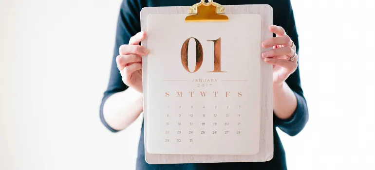 brooke-lark-BRBjShcA8D4-unsplash1.jpg Person holding a clipboard with January 2017 calendar page